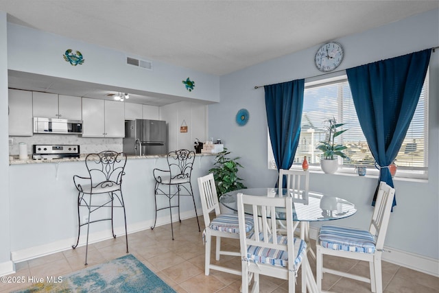 dining room featuring light tile patterned flooring