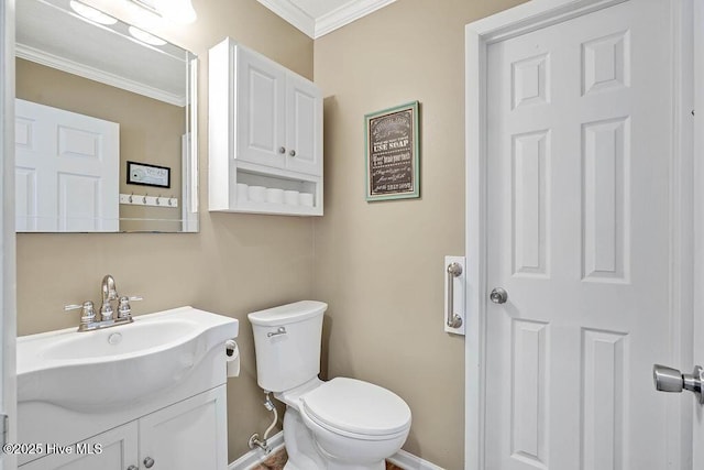 bathroom with toilet, crown molding, and vanity