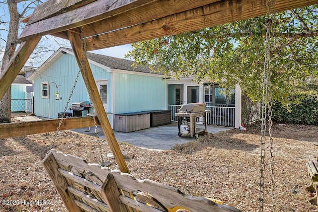 exterior space with a jacuzzi, a sunroom, and a patio