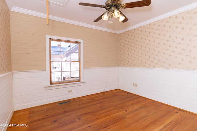 spare room with hardwood / wood-style flooring, ceiling fan, and ornamental molding