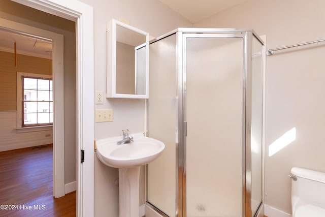 bathroom featuring hardwood / wood-style flooring, toilet, and walk in shower