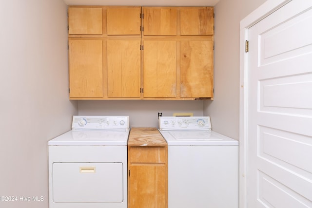 washroom featuring cabinets and independent washer and dryer