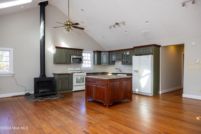 kitchen featuring wood-type flooring, white appliances, high vaulted ceiling, and a kitchen island