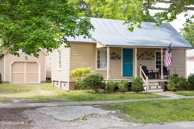 412 Phillips St, Edenton, NC 27932 - view of front of property with a porch, an outdoor structure, a garage, and metal roof