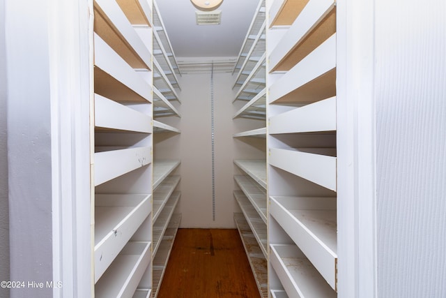 walk in closet featuring hardwood / wood-style floors