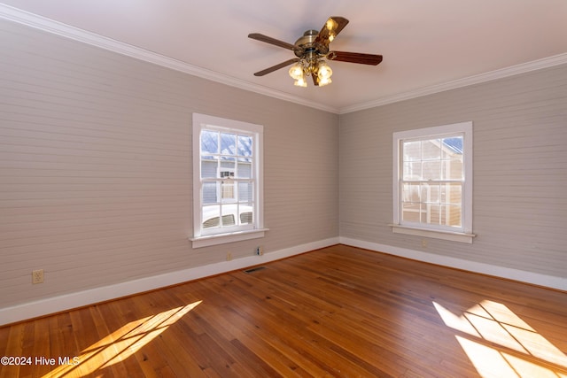 spare room with ceiling fan, wood-type flooring, and ornamental molding