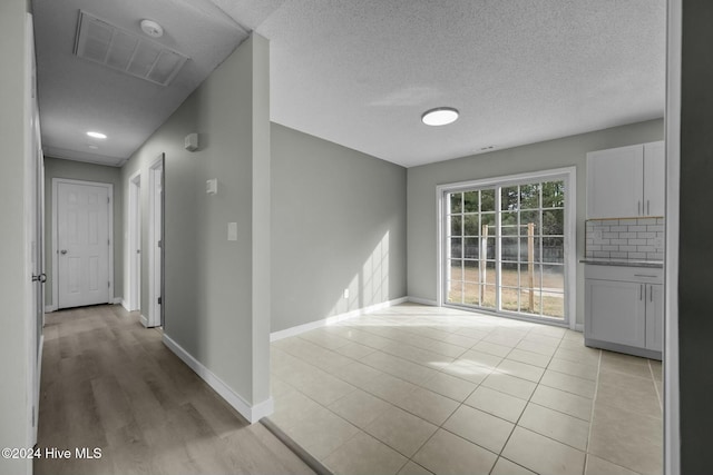 corridor with light tile patterned floors