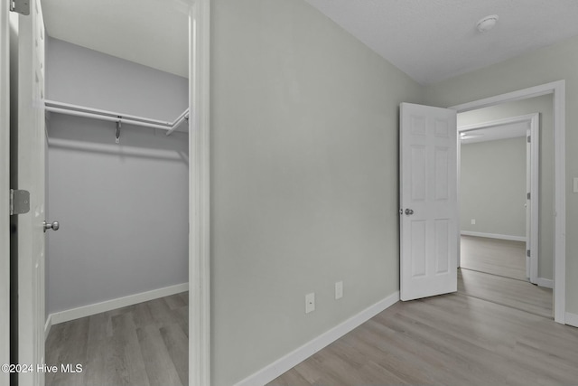 unfurnished bedroom featuring light hardwood / wood-style floors and a closet