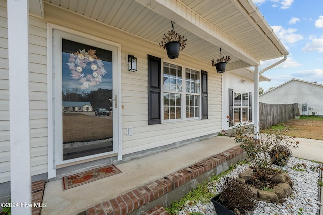 view of exterior entry with a porch