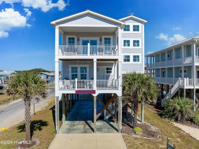 coastal inspired home with a balcony and a carport