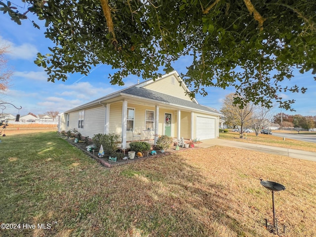 view of front of home featuring a garage, covered porch, and a front lawn