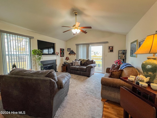 living room featuring light wood-type flooring, vaulted ceiling, and ceiling fan