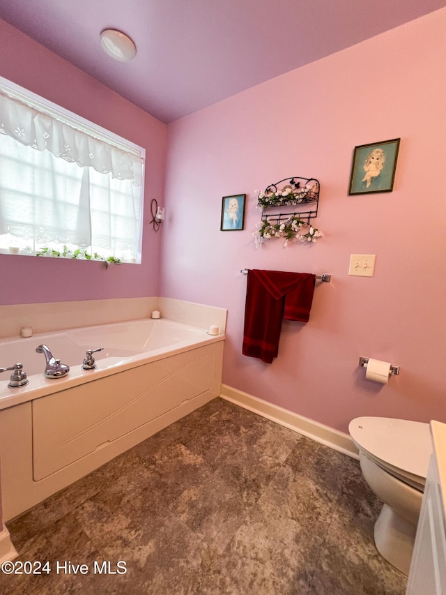 bathroom featuring a bathtub and toilet