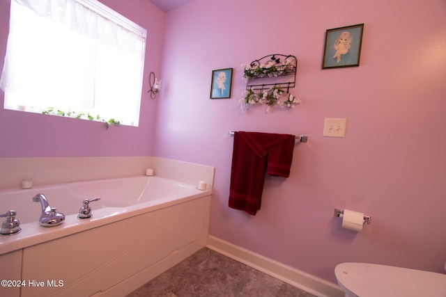 bathroom featuring toilet and a tub