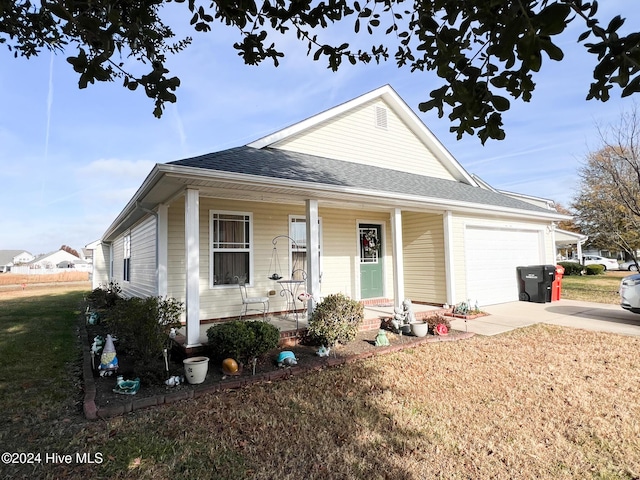 view of front of property with a front yard and a garage