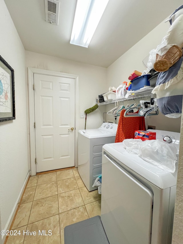 laundry room with light tile patterned floors and independent washer and dryer