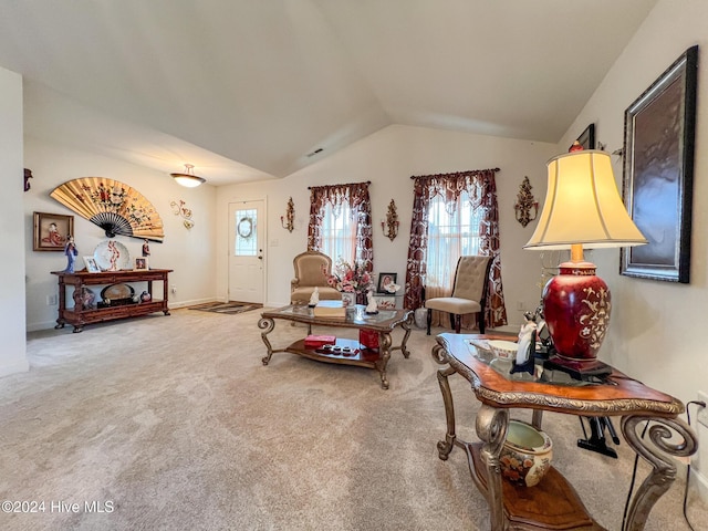 carpeted living room with lofted ceiling