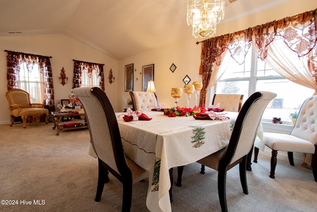 dining space with a chandelier, light colored carpet, vaulted ceiling, and plenty of natural light