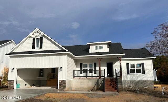 view of front of house with a porch and a garage