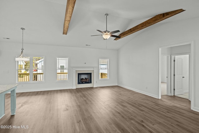 unfurnished living room with ceiling fan, high vaulted ceiling, dark hardwood / wood-style floors, and beamed ceiling