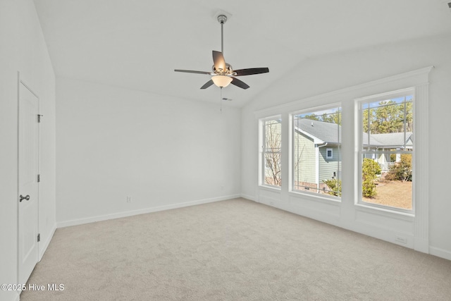 unfurnished room with vaulted ceiling, light carpet, and ceiling fan