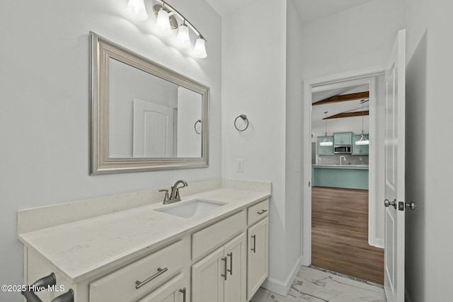 bathroom featuring beamed ceiling and vanity