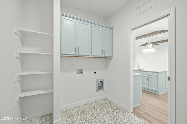 laundry room featuring gas dryer hookup, light hardwood / wood-style flooring, hookup for a washing machine, cabinets, and hookup for an electric dryer