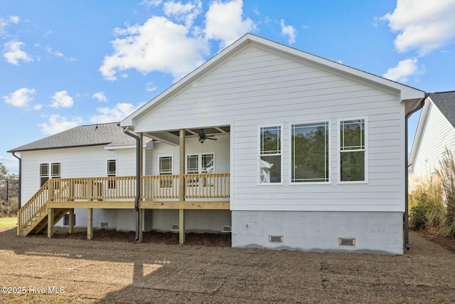 rear view of property featuring a wooden deck and ceiling fan