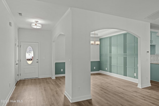 foyer entrance featuring hardwood / wood-style flooring and ornamental molding