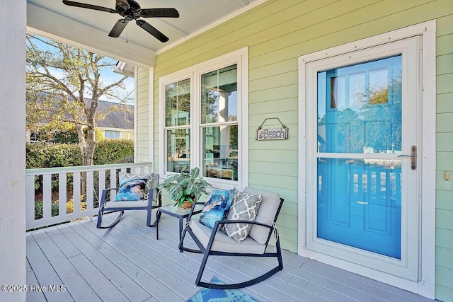 wooden terrace with a porch and ceiling fan