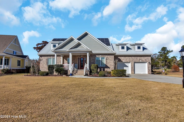 craftsman-style house with solar panels, a porch, and a front lawn