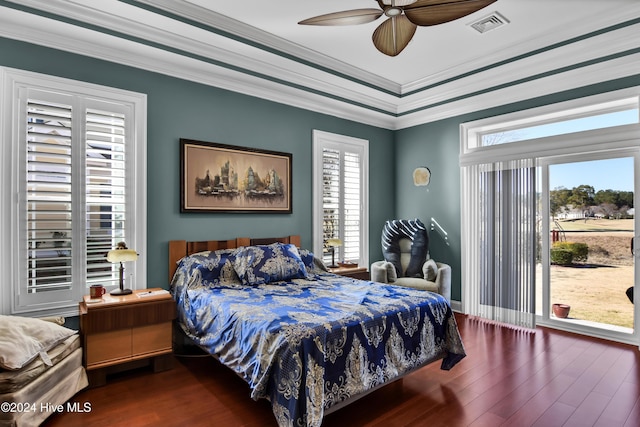 bedroom with crown molding, ceiling fan, and dark wood-type flooring