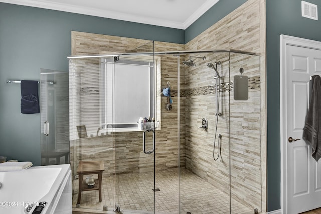 bathroom with crown molding, an enclosed shower, and washer / dryer