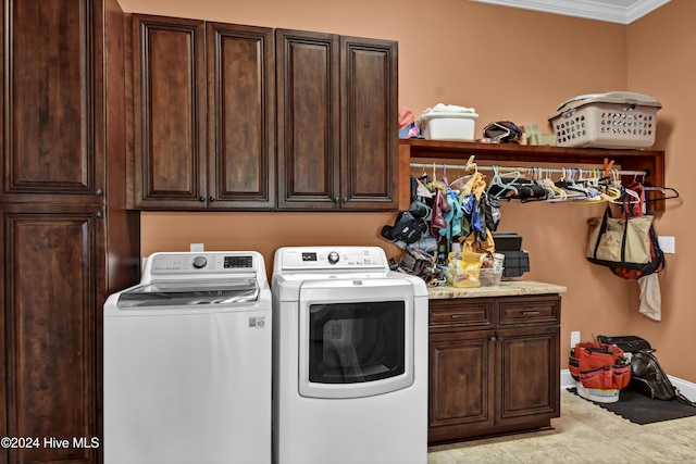 clothes washing area featuring washer and dryer, light tile patterned flooring, cabinets, and ornamental molding