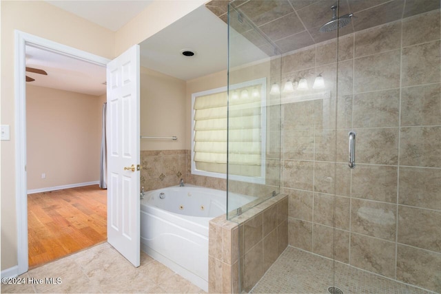 bathroom with wood-type flooring and independent shower and bath