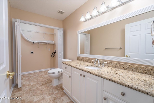 bathroom with vanity and toilet