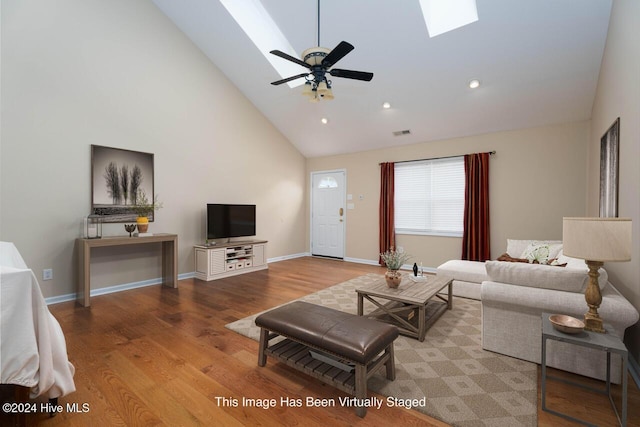 living room featuring ceiling fan, high vaulted ceiling, and light hardwood / wood-style flooring