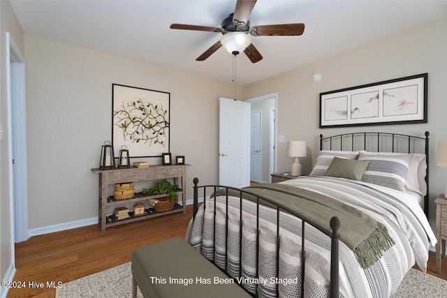 bedroom with hardwood / wood-style floors and ceiling fan