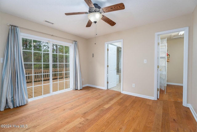 interior space featuring access to exterior, ensuite bathroom, light hardwood / wood-style flooring, and ceiling fan