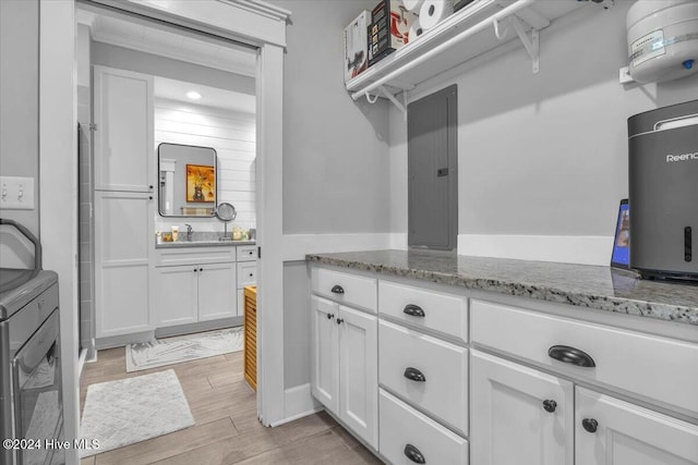 laundry area featuring sink, washer and clothes dryer, and electric panel