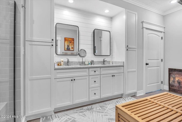 bathroom with ornamental molding and vanity