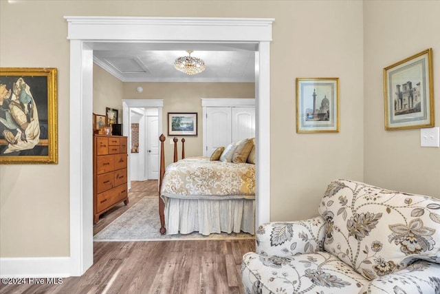 bedroom featuring crown molding and wood-type flooring