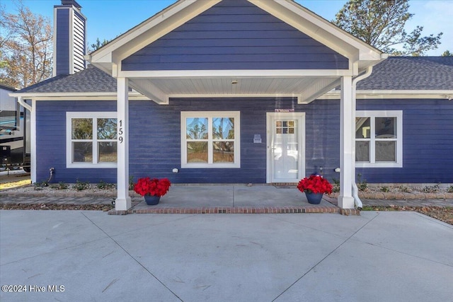 view of exterior entry with a porch