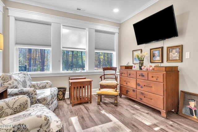 sitting room featuring light hardwood / wood-style floors and crown molding