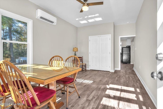 dining space with ceiling fan, light wood-type flooring, and a wall mounted AC