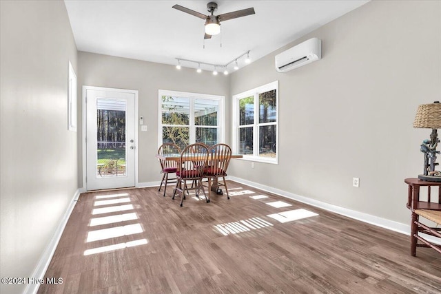 dining room featuring a wall unit AC, ceiling fan, and hardwood / wood-style flooring