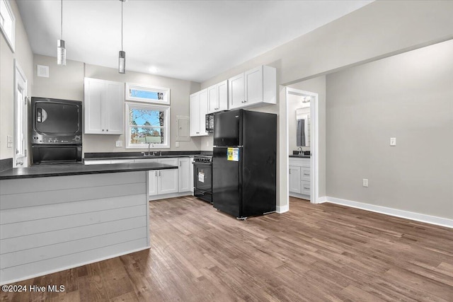 kitchen featuring sink, white cabinets, black appliances, and hanging light fixtures