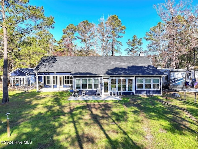 rear view of property featuring a patio area and a yard