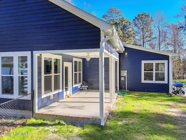 rear view of house featuring a yard and a patio area