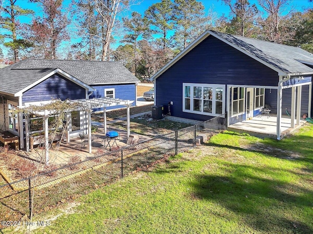 back of property featuring central AC, a patio area, a pergola, and a yard